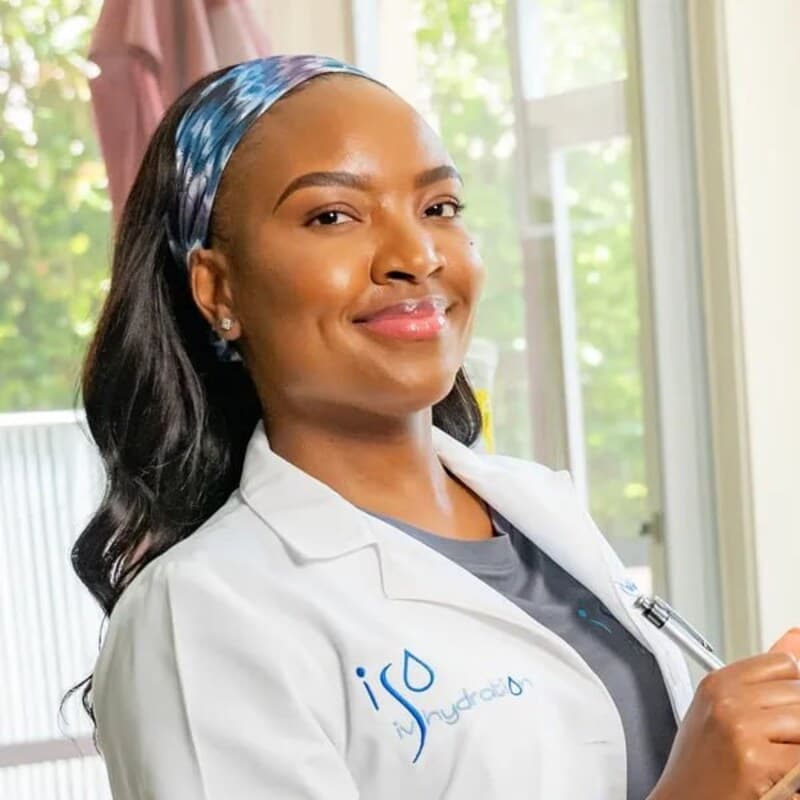 Jheanelle Bailey, licensed nurse and founder of Iso IV Hydration, in an Iso IV white coat